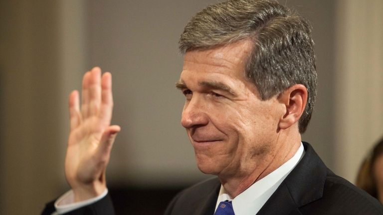 After fighting virus, storms and Republicans, departing North Carolina Gov. Cooper focuses on wins