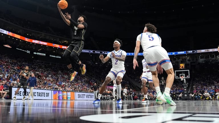 Sixth-seeded Kansas holds off No. 14 UCF 98-94 in overtime to reach Big 12 Tournament quarterfinals