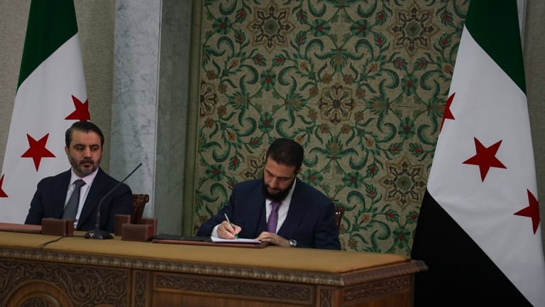 Syrian leader signs constitution that puts the country under an Islamist group’s rule for 5 years