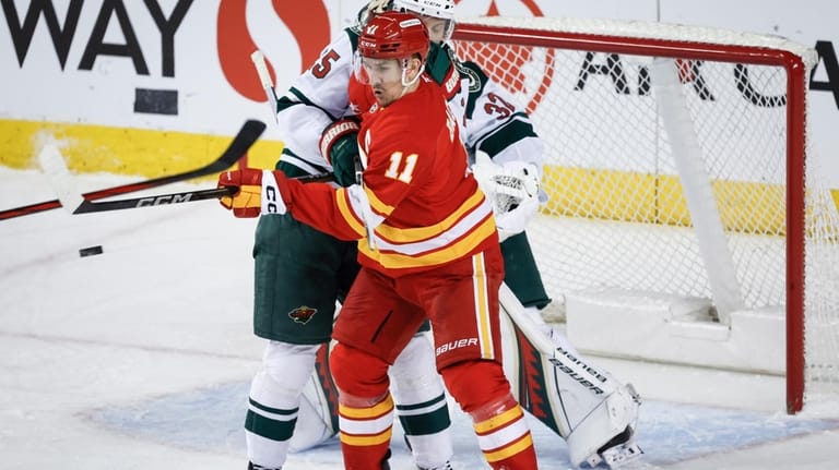 Flames beat Minnesota 4-2 to prevent the Wild from clinching a playoff spot